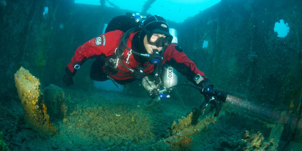 properly weighted diver floats through a wreck